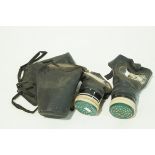 Two WWII gas masks and cases,