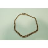 A 9ct gold watch chain, of graduated solid curb links, with two swivels, 32 cm long, 24.