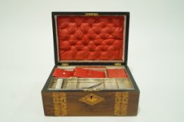 A Victorian walnut work box with parquetry inlay, the interior cover silk lined 14 cm high 30.