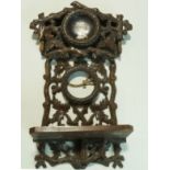 A Victorian carved Black Forest wall shelf with inset porcelain plaque painted with the bust of a