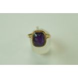 An amethyst single stone 9 carat gold ring, finger size Q, 3.