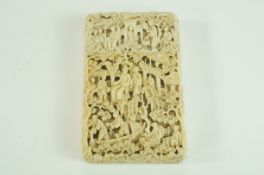 A late 19th century Cantonese carved ivory card case, decorated with figured, trees,