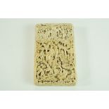 A late 19th century Cantonese carved ivory card case, decorated with figured, trees,
