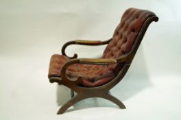 A leather armchair with show mahogany X frame
