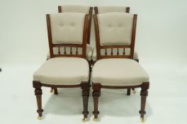 A set of four Victorian chairs on turned tapering legs with later brass casters