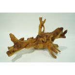 A root carving in the form of two iguanas on a tree branch, 46cm high, 92cm wide,