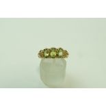 A 9 carat gold three stone peridot ring, in the Victorian style, finger size P, 4.