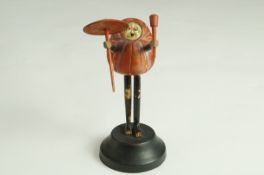 A late 19th century Japanese carved wooden Kobe figure holding a parasol and a club,