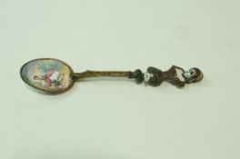 A 19th century Viennese gilt and enamel spoon, unmarked, with a figural finial,