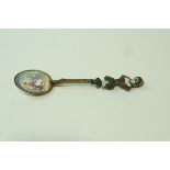 A 19th century Viennese gilt and enamel spoon, unmarked, with a figural finial,