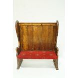 A pine settle with plank back and upholstered seat, 142cm high,