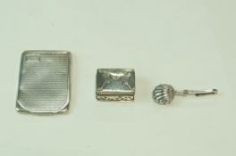 A silver shell motif napkin clip; a silver book of matches holder;