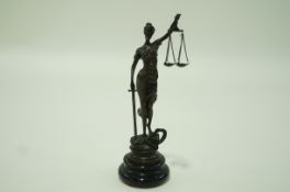 A bronze Garanti figure of Justice holding scales aloft and a sword, on a marble base,