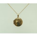 A 9 carat gold circular locket, 1.7 cm in diameter, on a chain, 44 cm long, 3.