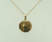 A 9 carat gold circular locket, 1.7 cm in diameter, on a chain, 44 cm long, 3.