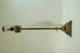 A Victorian brass oil lamp with reeded stem and round base on three round feet, overall 155.