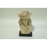 An Austin sculpture in clay of a ladies bust wearing a straw hat with flowers to the rim,
