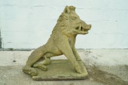 A reconstituted stone figure of a boar, on a rectangular plinth,