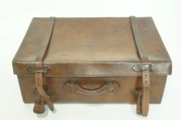 A late Victorian leather suitcase, with twin leather straps and handle, 54cm wide,