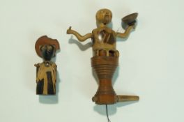 A Japanese Kobe toy in the form of a figure with moving arms on turned stand,