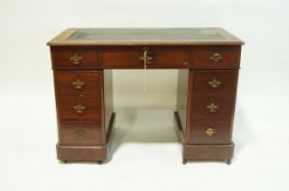 A Victorian mahogany pedestal desk with leather inset top,