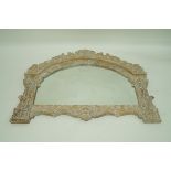 An overmantle mirror with arched carved frame, 94cm high,