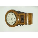 A Victorian walnut wall clock with carved and inlaid case, enclosing around a painted dial,