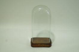 A glass clock dome of rectangular form on associated Victorian rosewood and marquetry plinth on bun