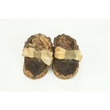 A pair of miniature straw shoes with ribbon fronts, velvet toes and leather soles,