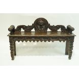 A Victorian oak hall bench with elaborately carved back frieze and legs, 121cm wide,