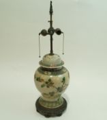 A Chinese crackle glaze vase and a cover painted in famille verte enamels on pierced metal stand