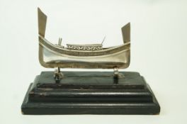 A Maltese silver model of a Luzzu, stamped '925', on an ebonised wooden plinth,