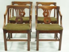 A set of four mahogany elbow chairs with pierced splats and square legs linked by stretchers