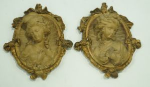 A pair of decorative wall plaques,