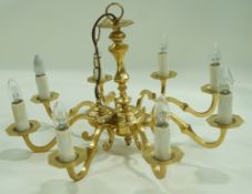 A brass hanging chandelier with eight branches. 37cm high. 68cm diameter.
