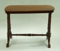 A Victorian mahogany centre table on turned supports and splayed legs linked by a turned stretch.