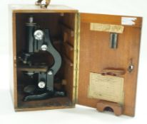 A Walton & Sons cased microscope in mahogany case with leather handle. 36cm high, 22.5cm wide, 24.