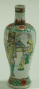 A Chinese porcelain vase painted in famille verte palette with figures. 26cm high.