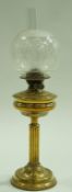 A brass oil lamp with round etched glass shade. 65cm, high.