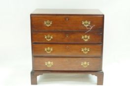 A George III mahogany secretaire chest of four drawers with brass handles and bracket feet,