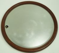 A Victorian mahogany framed round wall mirror, with bevelled glass, 74.