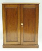 A mahogany standing cupboard with two panelled doors on plinth base. 93.