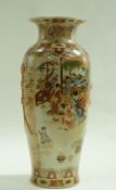 A Japanese earthenware floor vase, decorated with figures on a flower and leaf ground. 82.5cm high.