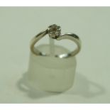 A 9 carat white gold seven stone diamond cluster ring, of cross over design, finger size L 1/2, 2.