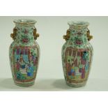 A pair of Canton enamel two handled vases painted with figures on a flower and butterfly ground,