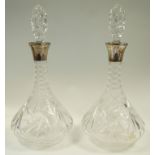 A pair of silver mounted cut glass decanters and stoppers, maker E.S.C., Birmingham 1974, 33.