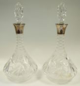 A pair of silver mounted cut glass decanters and stoppers, maker E.S.C., Birmingham 1974, 33.