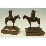 Two bronze figures of native Americans on horseback,