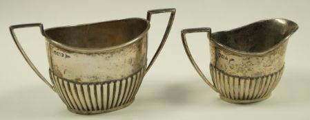 A late Victorian silver milk jug and sugar bowl, Walker & Hall, Sheffield 1898,
