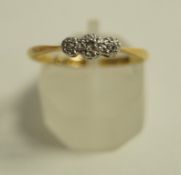 A three stone diamond ring, stamped '18ct Plat', the rose cuts illusion set, finger size O1/2,